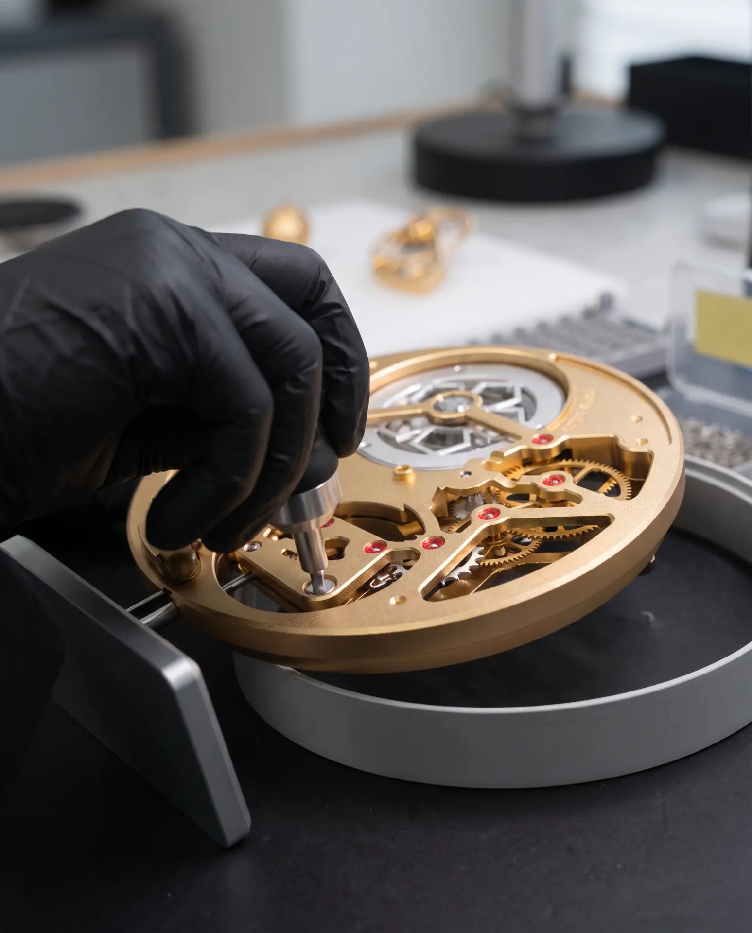 MECA TRADITION — Watchmaker finishing the movement at the workbench